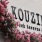 Kouzina Greek Taverna & Bar signage with flowers in front near 18 Dock luxury apartments in Stamford, CT.